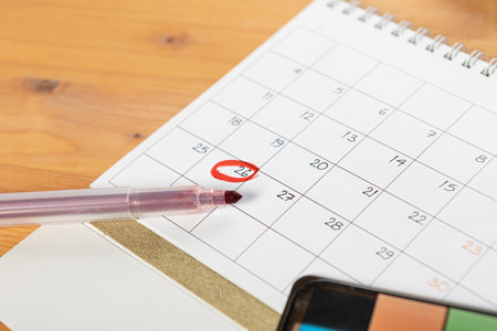Calendar and agenda reminders, work from home online. desktop calendar with stationery and pen pencil, keyboard. mark a holiday trip or plans in a diary at the office desk. 2023 calendar reminder concept.の写真素材