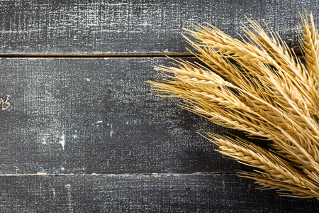 Wheat Ears on the Wooden Table. Sheaf of Wheat over Wood Background. harvest conceptの写真素材