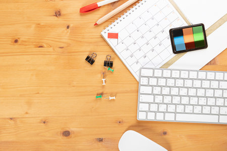 Calendar and agenda reminders, work from home online. desktop calendar with stationery and pen pencil, keyboard. mark a holiday trip or plans in a diary at the office desk. 2023 calendar reminder concept.の写真素材