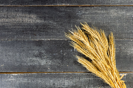 Wheat Ears on the Wooden Table. Sheaf of Wheat over Wood Background. harvest conceptの写真素材