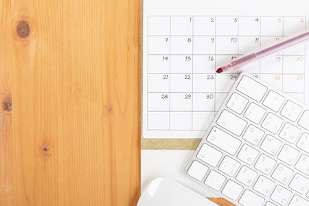 Calendar and agenda reminders, work from home online. desktop calendar with stationery and pen pencil, keyboard. mark a holiday trip or plans in a diary at the office desk. 2023 calendar reminder concept.の写真素材