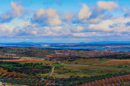 Landscape and castle of the city of Feria located in Extremadura, Spain. Landscape of a town and its castle with a beautiful valley and blue sky surrounded by nature.のeditorial素材