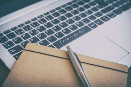 Teleworking concept. Technology. Keyboard with telework button. Concept for any illustration of teleworking or teleworking and home workersの写真素材