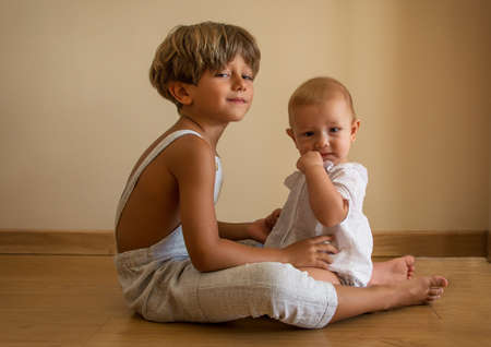 Portrait Of Beautiful Siblings Playing At Home Portrait of beautiful siblings playing at home. Family concept.の写真素材