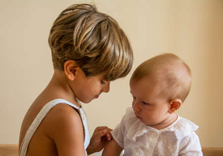 Portrait Of Beautiful Siblings Playing At Home Portrait of beautiful siblings playing at home. Family concept.の写真素材