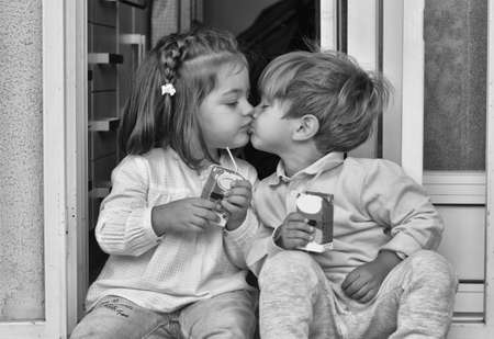 Kisses. Hugs and kisses of two little boys. Cute babies having fun on the kindergarten floor.の写真素材