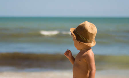Beautiful Child Smiling On The Beach. Close-up Of A Child On The Beach. Summer Conceptの写真素材