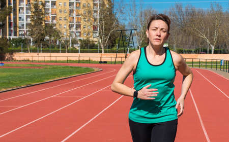 Sports Women running on a race track. Copy Space. Sport Concept