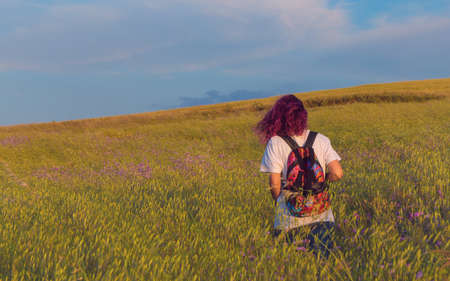 Young Woman Enjoying A Walk Through A Field. Spring Conceptの写真素材