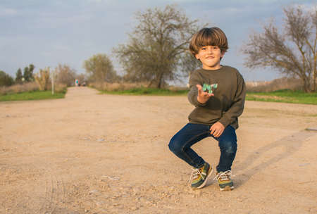 Marbles. Child Playing Marbles On The Ground.