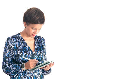 Modern attractive woman with tablet, looking at the tablet.の写真素材