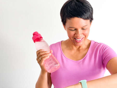 Brown woman with water bottleの写真素材