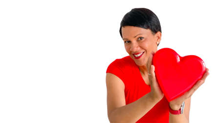 Attractive dark skinned woman with red heart on a white background.の写真素材