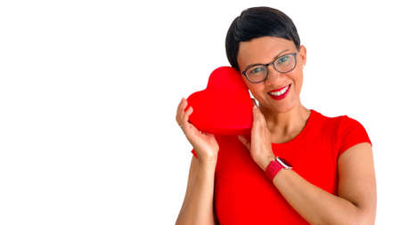 Attractive dark skinned woman with red heart on a white background.の写真素材