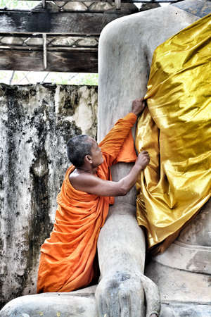 A monk living his simple life at a temple in Thailand.の素材