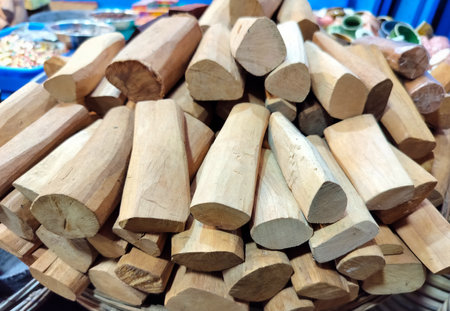 Sandalwood sticks placed naturally on a rustic surface, showcasing their rich texture and earthy...
