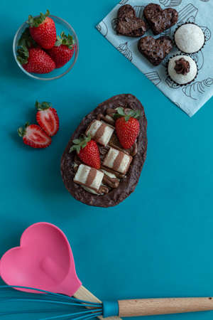 Delicious Easter egg stuffed with chocolate and strawberries. Top view.の写真素材