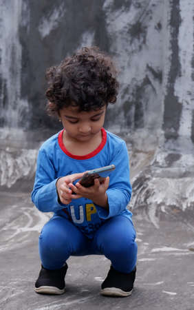 two year old baby girl watching smart phone