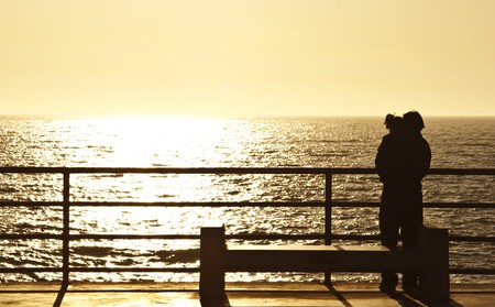 a couple huging by the sunsetの写真素材