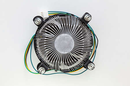 Heatsink fan of a microprocessor on a white background. It has yellow, black, blue and green colored cables and a connector for the motherboard.の写真素材