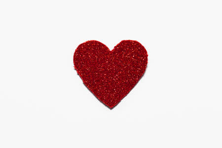 Red glitter heart on white background with space for text in which you can make a Valentine's greeting.の写真素材