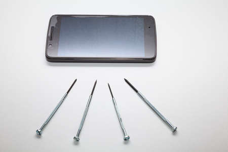 Small screwdrivers to repair a smartphone or any other electronic device with small parts. Everything is placed on a white background.の写真素材