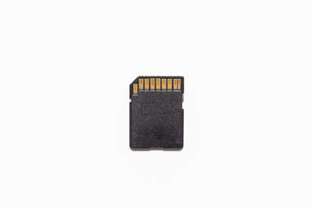 Black SD memory card placed on a white background. The connectors are gold colored.の写真素材