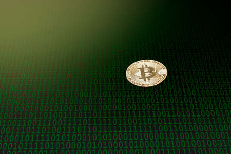 Isolated gold cryptocurrency on a dark abstract background on which there is a mosaic of green zero...