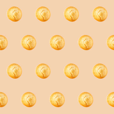 Top view of many cupcakes placed on a beige background. This image can be used as a seamless...