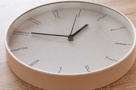 Close-up of a large round clock hand marking ten to two o'clock.の写真素材