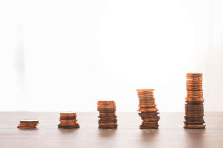 Several stacks of 1, 2 and 5 cent coins symbolizing the bars of an upward trending graph.