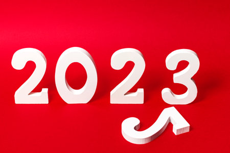 Number 2023 of white wooden figures on red background with a number 2 lying down.の写真素材