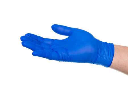 Crop unrecognizable hand of person in rubber glove with palm up for demonstration isolated on white backgroundの写真素材