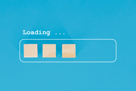 Minimalist visual metaphor of a loading progress bar depicted by wooden blocks on a blue background.
