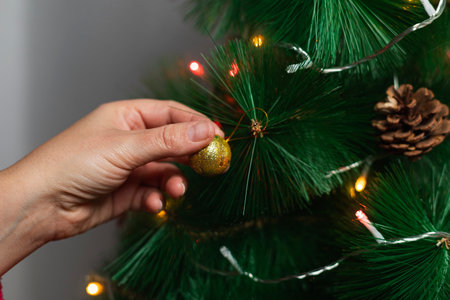 Unrecognizable person's hand placing a Christmas ballの写真素材