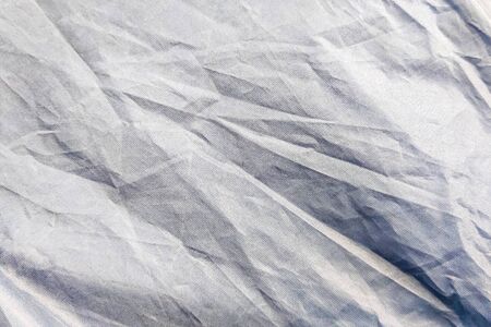 Beautiful closeup background with gray crumpled raincoat fabric. Ideal for use in the design or...