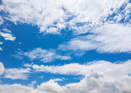 Blue sky and many white big clouds in daylight. Natural sky composition. Ideal for use in the design...