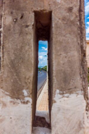 A Hole in a concrete wall with city view.の写真素材