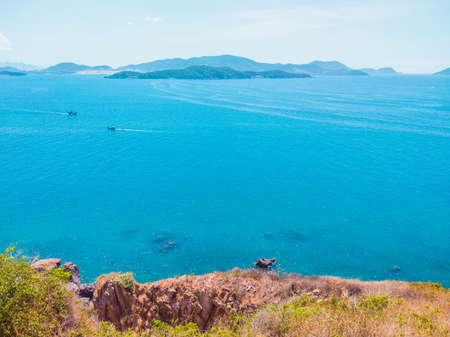 Deep blue ocean panorama with boat in a turquoise tropical sea under clear sky background. Tropical...