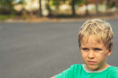 Portrait handsome cute serious sad blond boy in bad mood look away. Artistic emotions. Problem or...
