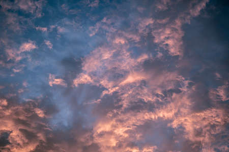 Celestial World concept. Dark purple blue pink natural bright sunset sky cumulus clouds. Background natural color of evening cloudscape panorama. Ideal for design wallpaperの写真素材