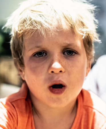 Close blond child boy expressions sad disappointment pain annoyance tragedy hopelessness bad mood, Illness sick, open mouth bruises eyes. Tooth ache, childhood problems harassment abuse conceptの写真素材
