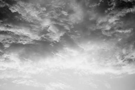 Celestial World concept. Fiery black white natural bright dramatic sunset sky with clouds. Background color of evening cloudscape panorama. Ideal for design wallpaperの写真素材
