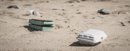 BANNER trash white foam fast food container for take away service, a lot plastic spilled trash on sea nature beach sand sun day, problem earth ocean pollution contamination, environmental protectionの写真素材