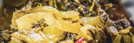 BANNER Spicy asia or korean vegan vegetable food. Photo use as design dark background for restaurant, street meal, healthy unhealthy dish concept. Marinated cabbage fried in oil. Green yellow colourの写真素材