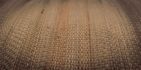 BANNER Real nature background. Blur effect. Close-up Woven method bamboo cane straw pattern texture mat. East Asia traditions. Calm spa warm mood concept. Wheat beige tone collection in stockの写真素材