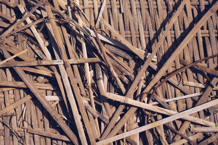 Real nature abstract background. Bamboo straws weaving texture mat, light gray yellow brown beige colour vintage effect. Calm warm simple life style mood, minimalism, design wallpaper backdropの写真素材