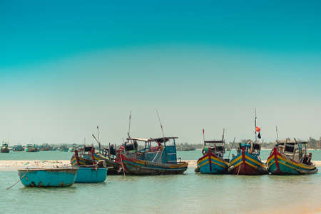 Aquamarine azure seascape clear sky view. Real nature beauty background. Red blue motor boats sail...