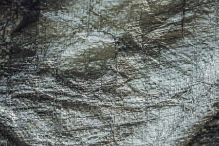 Abstract real fabric surface background. Aluminum Platinum Silver foil Tarpaulin effect with rough texture burlap edge. Futurism 80s retro style new year. Dark Grey black tone design. More in stock.の写真素材