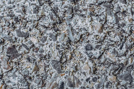 Abstract real photo grunge background. Light Grey gravel concrete asphalt road macro close up...
